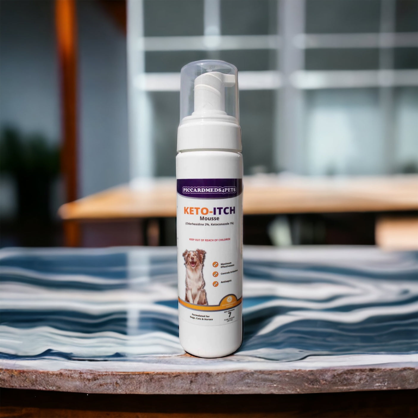 Keto-Itch mouse spray bottle on a table with a blurred background