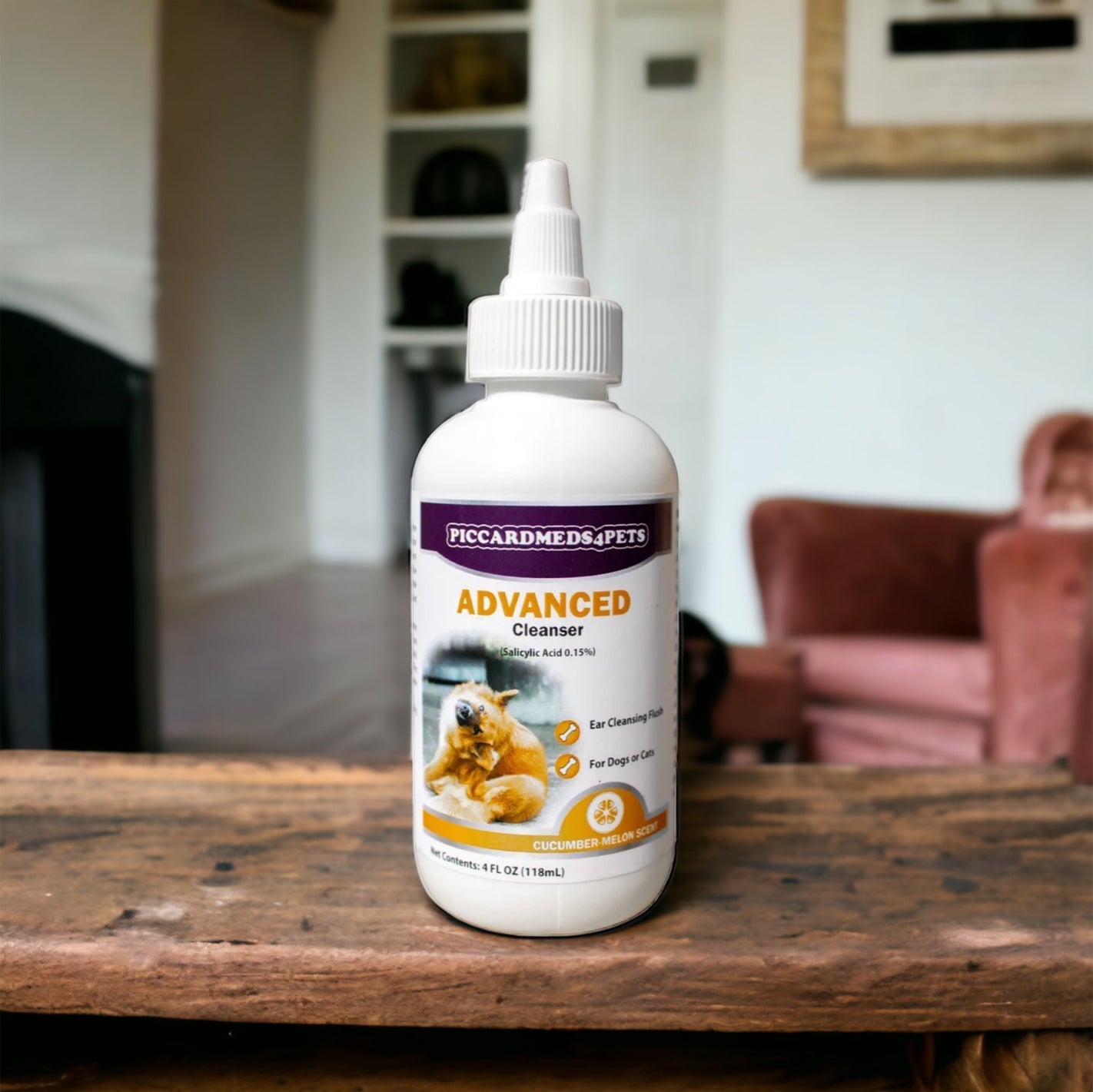 Bottle of Piccard Meds & Pets Advanced Cleanser on a wooden table with a blurred indoor background