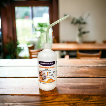 Bottle of chlorhexidine gluconate on a wooden table with a blurred indoor background