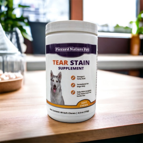 Tear stain supplement container for dogs on a wooden surface with a blurred indoor background